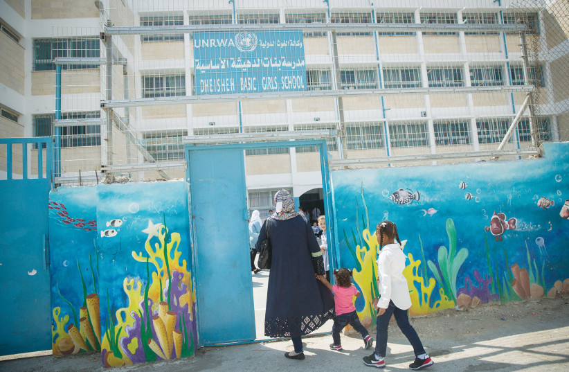  THE ENTRANCE to an UNRWA school in Bethlehem: Schoolchildren are taught a poem that encourages them to die as martyrs by killing Israelis, described as a ‘hobby,’ says the writer. (credit: MIRIAM ALSTER/FLASH90)