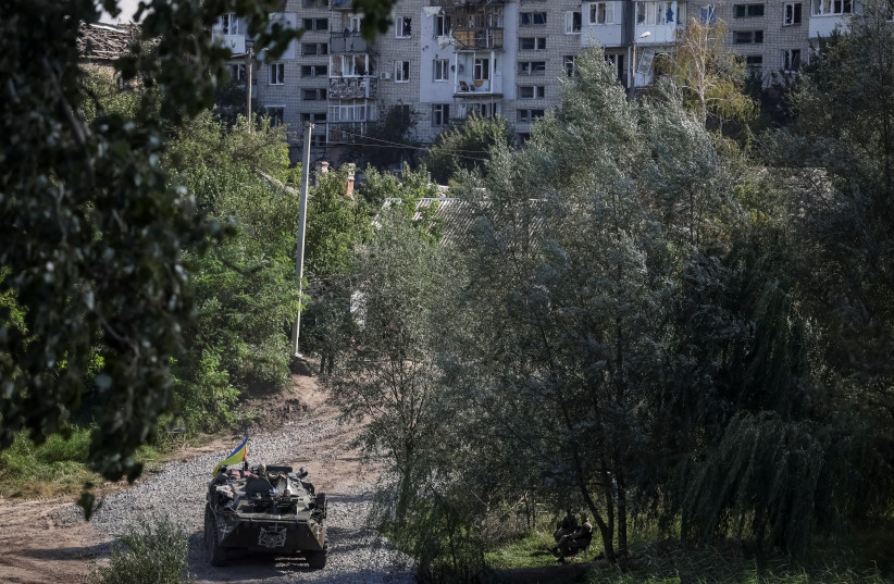 A Ukrainian Armored Personnel Carrier (APC) drives, as Russia's attack on Ukraine continues, near the town of Izium, recently liberated by Ukrainian Armed Forces, in Kharkiv region, Ukraine, September 19, 2022. (photo credit: REUTERS/GLEB GARANICH)