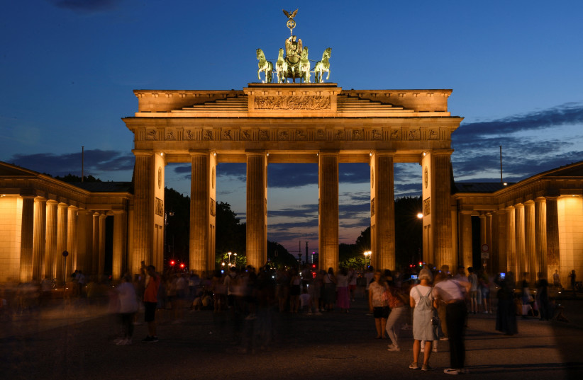 A general view of the illuminated Brandenburg Gate is pictured during the night in Berlin, Germany, August 3, 2022. (photo credit: REUTERS/ANNEGRET HILSE)