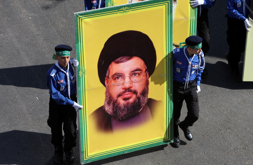  Lebanon's Imam al-Mahdi Scouts carry a picture of Lebanon's Hezbollah leader Sayyed Hassan Nasrallah as they march during a religious procession to mark Ashura in Beirut's suburbs, Lebanon August 9, 2022. (credit: REUTERS/AZIZ TAHER)