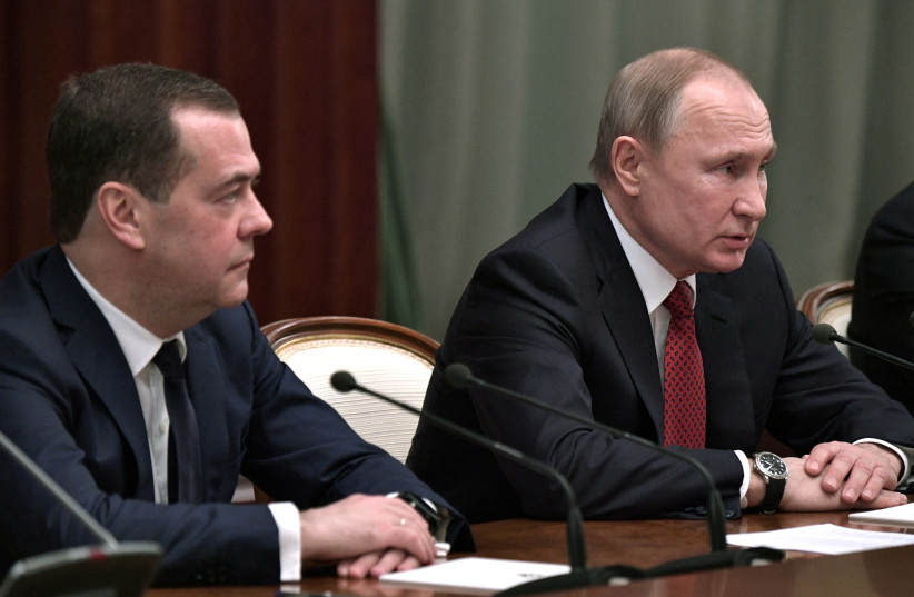  Russian President Vladimir Putin and Prime Minister Dmitry Medvedev attend a meeting with members of the government in Moscow, Russia January 15, 2020. (photo credit: SPUTNIK/ALEXEY NIKOLSKY/KREMLIN VIA REUTERS)