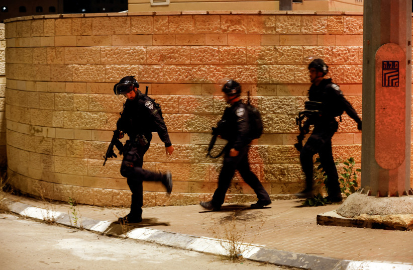   Israeli security forces are seen following a shooting incident at a check point next to Shuafat in east Jerusalem, October 10, 2022. (photo credit: AMMAR AWAD/REUTERS)