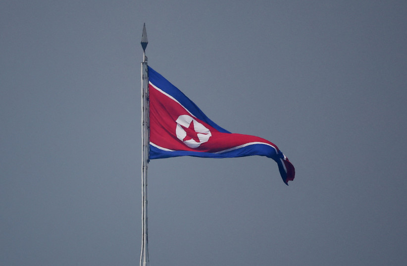A North Korean flag flutters at the propaganda village of Gijungdong in North Korea, in this picture taken near the truce village of Panmunjom inside the demilitarized zone (DMZ) separating the two Koreas, South Korea, July 19, 2022. (photo credit: REUTERS/KIM HONG-JI/POOL/FILE PHOTO)