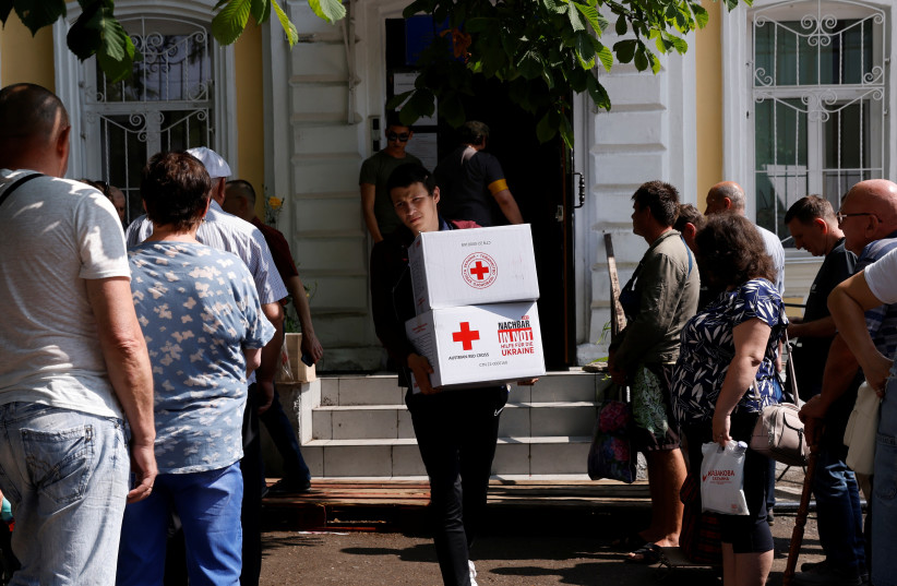 Residents stand in line to collect humanitarian aid at a Red Cross distribution point, as Russia's attacks on Ukraine continues, in Mykolaiv, Ukraine, June 10, 2022.