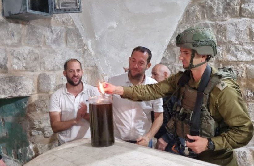  IDF soldier and worshippers at Joseph's Tomb (credit: SAMARIA REGIONAL COUNCIL)