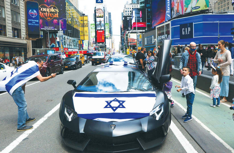  The Celebrate Israel Parade proceeds through Times Square in New York City, last year. When Israelis hear of Americans marching in the parade, they feel a sense of brotherhood, says the writer. (photo credit: CAITLIN OCHS/REUTERS)