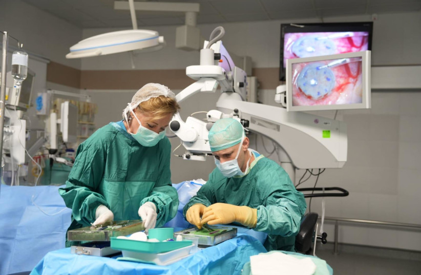  Dr. Assaf Freeman, director of the corneal service at the Meir Medical Center in Kfar Saba and nurse Tatiana during the corneal transplant operation in Benjamin Goren’s eye. (photo credit: MEIR MEDICAL CENTER)