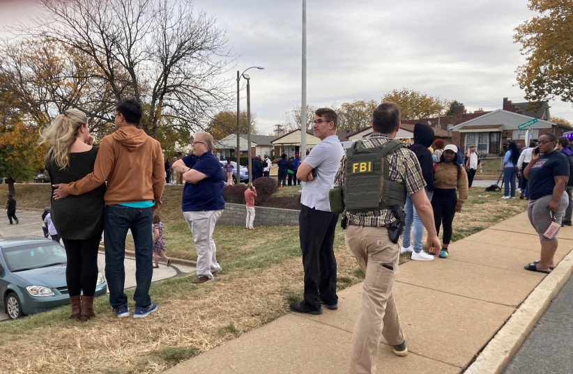  People gather following a shooting at a high school, in St. Louis, United States, October 24, 2022. (photo credit: Holly Edgell/NPR Midwest Newsroom/ via REUTERS)