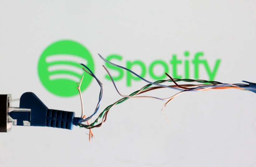  Broken Ethernet cable is seen in front of Spotify logo in this illustration taken March 11, 2022. (photo credit: REUTERS/DADO RUVIC/ILLUSTRATION)
