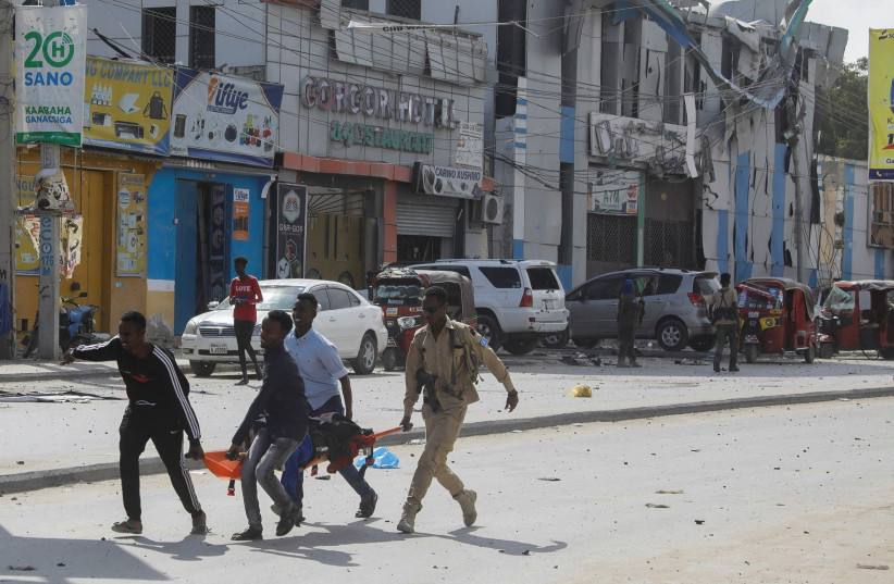  An injured civilian is evacuated from the scene of an explosion near the education ministry building along K5 street in Mogadishu (credit: REUTERS)