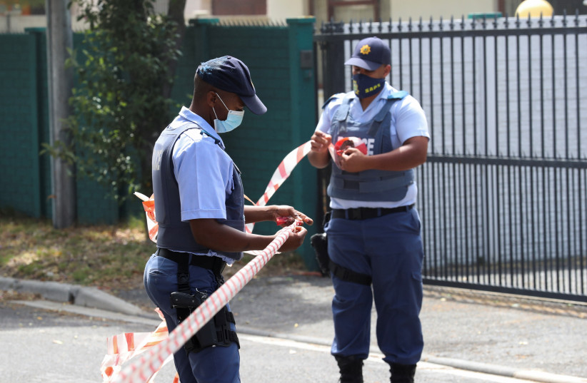  Police put up a cordon outside the home of Archbishop Desmond Tutu in Cape Town, South Africa, December 26, 2021.  (photo credit: REUTERS/MIKE HUTCHINGS)