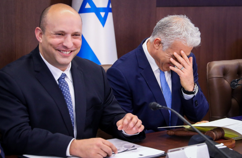  Prime Minister Yair Lapid and Alternate Prime Minister Naftali Bennett at cabinet meeting at the Prime Minister's office in Jerusalem on July 31, 2022. (photo credit: MARC ISRAEL SELLEM/POOL)