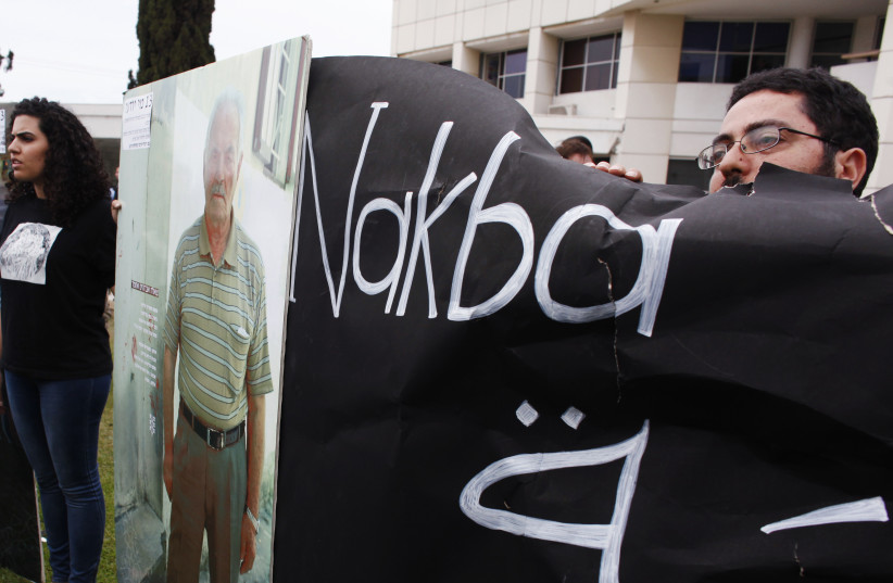  Pro-Palestinian demonstrators hold boards during a rally marking Nakba Day, outside Tel Aviv University (photo credit: NIR ELIAS/REUTERS)