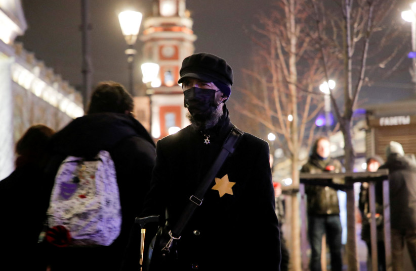  A person wearing a yellow star of David, being a reference to a symbol that Jews were forced to wear during II World War, walks during an anti-war protest against Russia's invasion of Ukraine, in Saint Petersburg, Russia March 2, 2022. (credit: REUTERS/STRINGER)