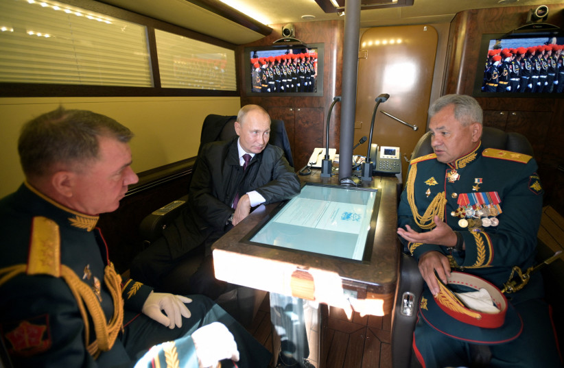  Russian President Vladimir Putin, Defence Minister Sergei Shoigu and Commander of the Western Military District of Russian Armed Forces Alexander Zhuravlyov are pictured aboard the Raptor patrol boat before the Navy Day parade in Saint Petersburg (photo credit: REUTERS)