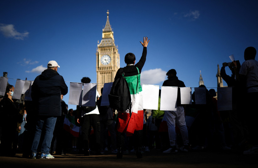  People demonstrate outside the Houses of Parliament during a protest against the Islamic regime of Iran following the death of Mahsa Amini, in central London, Britain, October 8, 2022.  (credit: REUTERS/HENRY NICHOLLS)