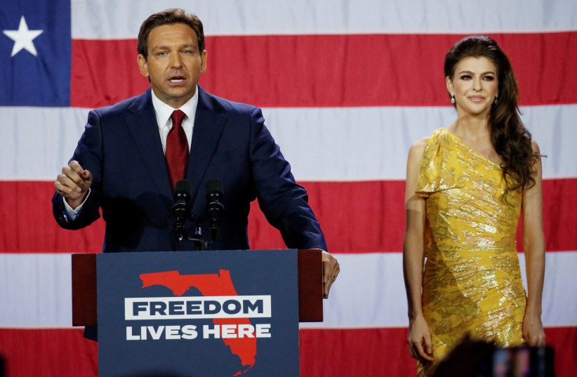  Republican Florida Governor Ron DeSantis speaks with his wife Casey DeSantis at his side during his 2022 US midterm elections night party in Tampa, Florida, US, November 8, 2022 (photo credit: REUTERS/MARCO BELLO)