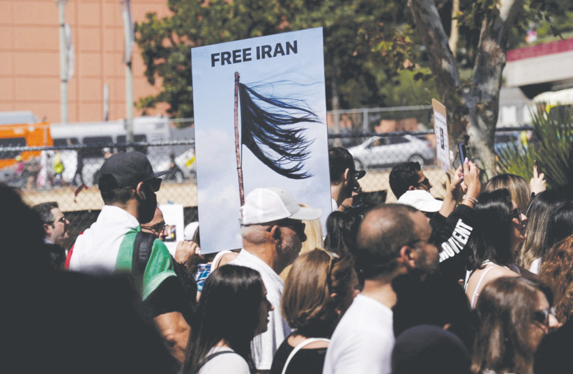  DEMONSTRATORS HOLD a ‘Free Iran’ sign, in Los Angeles last month, depicting a shorn hair, protesting in support of Iranian women and against the death of Mahsa (Zhina) Amini. On November 3, President Joe Biden argued the United States would free Iran (credit: REUTERS)