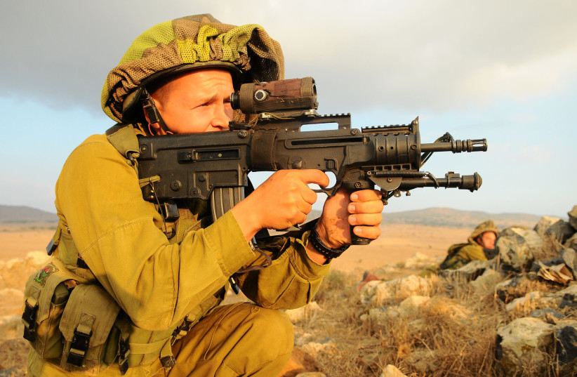  A soldier from the Granite Battalion of the Nahal Brigade is seen holding a Tavor rifle while training in the Golan Heights (Illustrative). (credit: Nir Gal, IDF Spokesperson's Unit/Flickr)