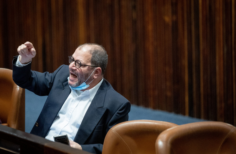  MK Ofer Cassif reacts during a plenum session in the assembly hall of the Knesset, the Israeli parliament in Jerusalem on January 19, 2022. (credit: YONATAN SINDEL/FLASH90)