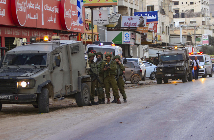 IDF soldiers secure the scene after a Border Police officer was stabbed in Huwara, December 2, 2022. (photo credit: NASSER ISHTAYEH/FLASH90)