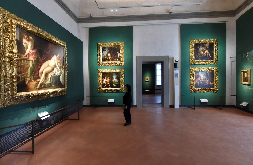  A woman looks at the painting ''Leda and the Swan'' by Jacopo Tintoretto during the inauguration of fourteen new rooms dedicated to 16th and 17th century painters, at the Uffizi Gallery Museum in Florence, Italy, May 29, 2019. (credit: REUTERS)