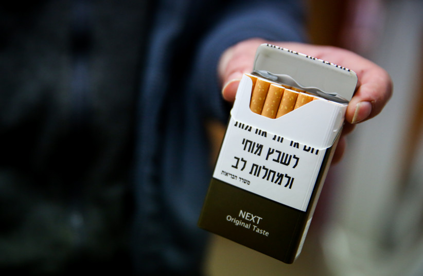  Cigarette packets highlighting the health risks of smoking shown at a convenience store in Tzfat, northern Israel, December 20, 2019. (credit: DAVID COHEN/FLASH 90)