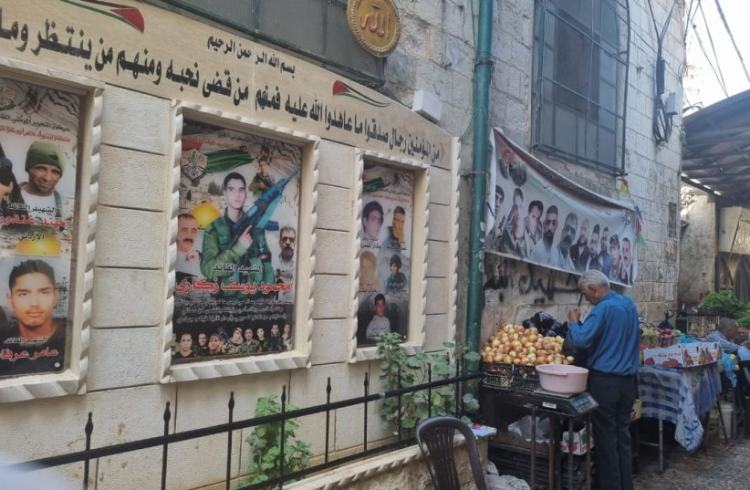  Wall displays in Nablus show pictures of deceased members of the Lion's Den terrorist group.  (credit: KHALED ABU TOAMEH)