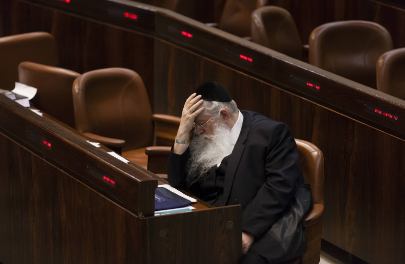 Israeli MKs of the United Torah Judaism party Meir Porush reacts as he sits in the plenum as the Knesset approves Yesh Atid's draft bill on first reading early Tuesday morning, in the Knesset, Israel's Parliament, in Jerusalem, early July 23, 2013 (photo credit: FLASH90)
