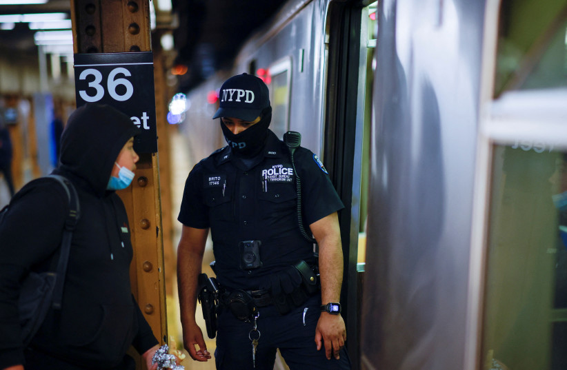  A New York police officer of the anti-terrorism unit patrols the 36th St. subway station, a day after a shooting incident took place in the Brooklyn borough of New York City, US, April 13, 2022 (credit: REUTERS/EDUARDO MUNOZ)