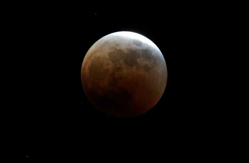  A moon is seen during a lunar eclipse, in Shanghai, China November 8, 2022.  (photo credit: ALY SONG/REUTERS)