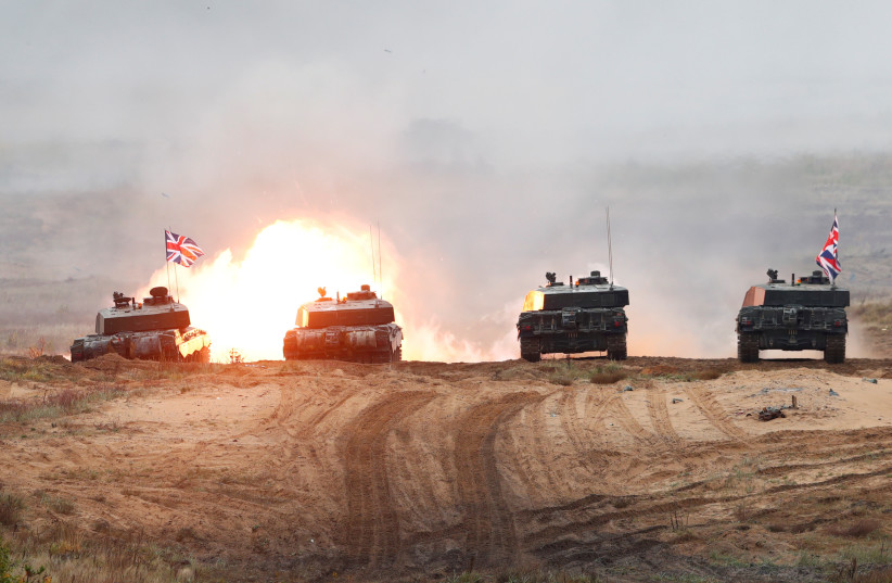  British Army Challenger 2 tank fires during NATO enhanced Forward Presence battle group Iron Spear 2019 exercise in Adazi, Latvia October 11, 2019.  (photo credit: REUTERS/INTS KALNINS)