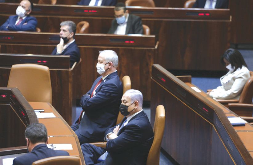  PRIME MINISTER Benjamin Netanyahu and then-defense minister  Benny Gantz sit at the head of the government table in the Knesset plenum, in 2021 (credit: ALEX KOLOMOISKY/FLASH90)