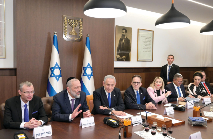  Israeli Prime Minister Benjamin Netanyahu is seen at a meeting of his new cabinet in Jerusalem. (credit: AMOS BEN-GERSHOM/GPO)