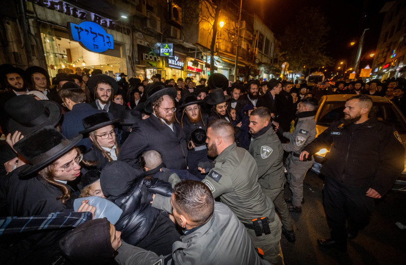 Police clash with Ultra orthodox Jewish men during a protest against a cellular shop in the Geula neighborhood, Jerusalem, on January 16, 2023. (photo credit: YONATAN SINDEL/FLASH 90)