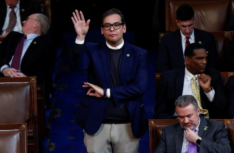  Newly elected Rep. George Santos (R-NY), who is facing a scandal over his resume and claims he made on the campaign trail, makes a gesture with his left hand as he casts his vote for House Republican Leader Kevin McCarthy from the House Chamber during a 10th round of voting for the new Speaker. (credit: REUTERS/Evelyn Hockstein/File Photo)
