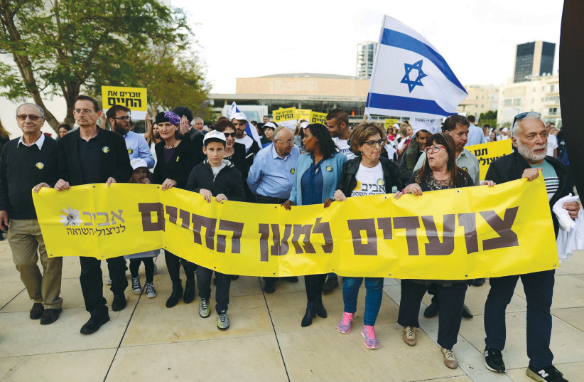  A MARCH takes place in Tel Aviv to raise awareness of the difficult living conditions of Holocaust survivors, in 2018. The large sign reads ‘Marching for Life,’ and carries the insignia of Aviv for Holocaust Survivors, a nonprofit organization. (photo credit: TOMER NEUBERG/FLASH90)