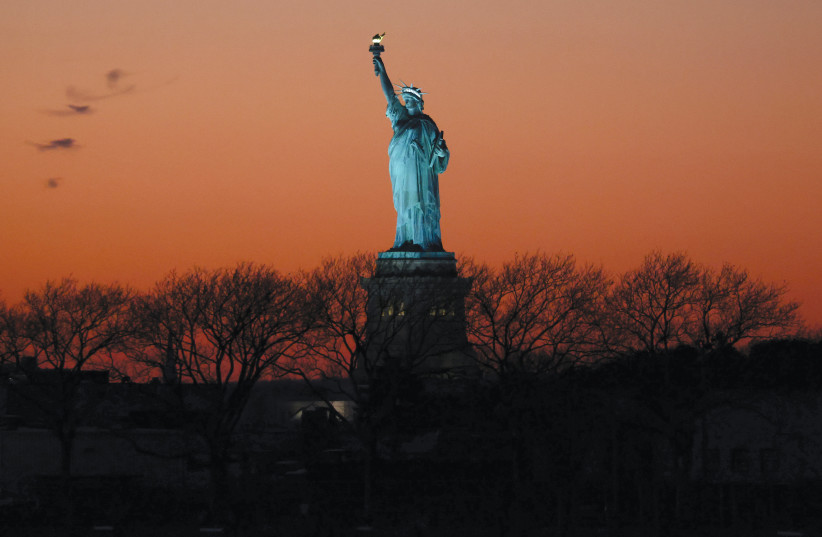  The Statue of Liberty is seen at sunset in New York City.  (credit: Andrew Kelly/Reuters)