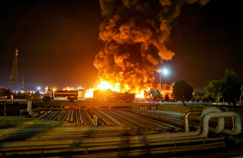  A picture taken late on June 2, 2021, shows fire raging at an oil refinery in the Iranian capital Tehran. - A fierce blaze broke out at the refinery in southern Tehran after a liquefied gas line leaked and exploded, the head of the capital's crisis team said on state television.  (photo credit: VAHID AHMADI/TASNIM NEWS/AFP VIA GETTY IMAGES)