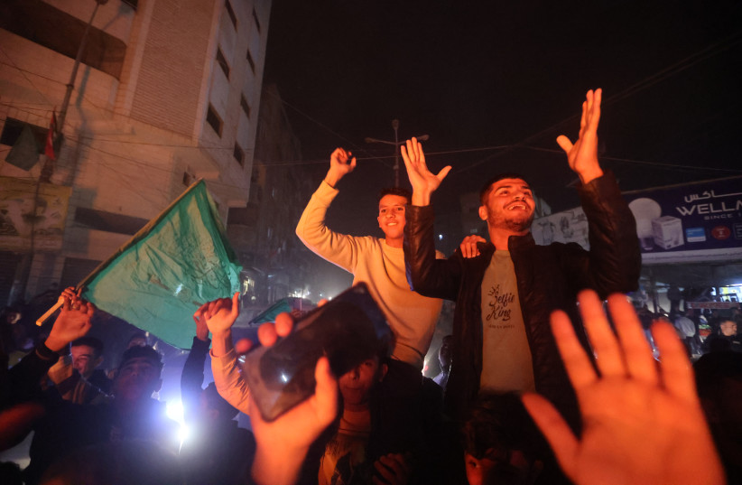  Palestinians celebrate following the deadly terror attack tonight, in Gaza City, on January 27, 2023 (credit: ATIA MOHAMMED/FLASH90)