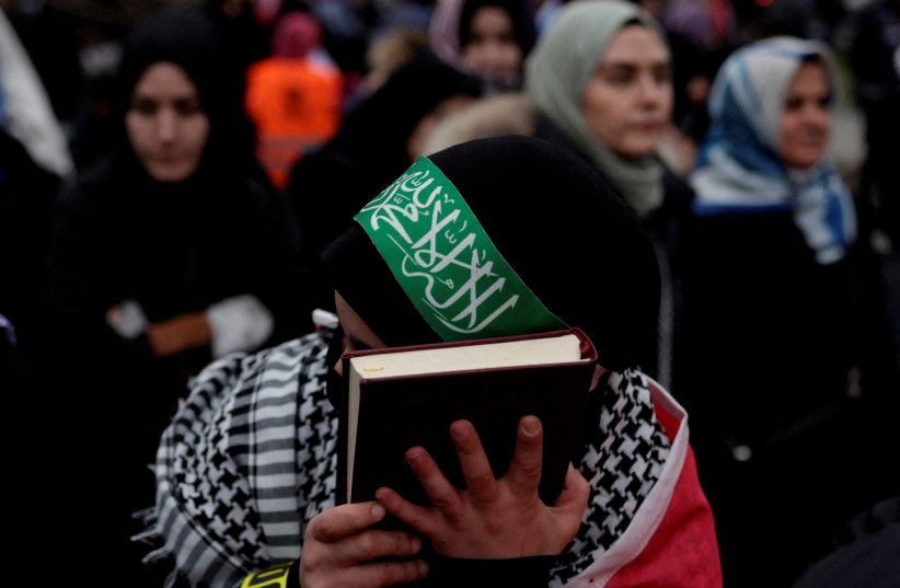  A woman holds a copy of the Koran during a protest following the burning of the Koran in Stockholm, in Istanbul, Turkey January 29, 2023. (credit: REUTERS/MURAD SEZER/FILE PHOTO)