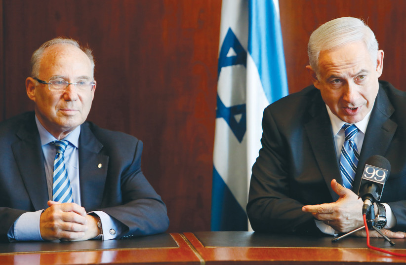  THEN-INCOMING Bank of Israel governor Jacob Frenkel and Prime Minister Benjamin Netanyahu hold a news conference in the Knesset, in 2013. (credit: MIRIAM ALSTER/FLASH90)