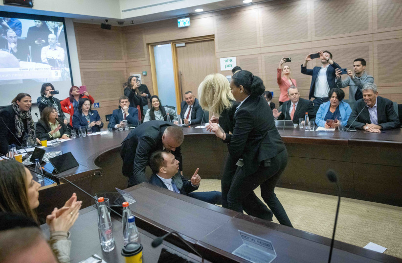  Israeli lawmakers are restrained amid a chaotic session of the Knesset Law and Constitution Committee in Jerusalem during a debate on judicial reform, on February 13, 2023. (credit: YONATAN SINDEL/FLASH90)