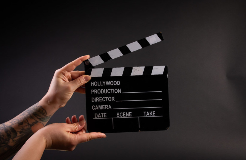  Illustrative image of person holding professional movie clapper board (photo credit: FLICKR)