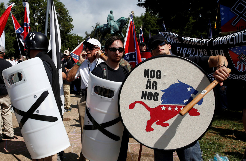 White supremacists stand behind their shields at a rally in Charlottesville, Virginia, US, August 12, 2017. (credit: REUTERS/JOSHUA ROBERTS)