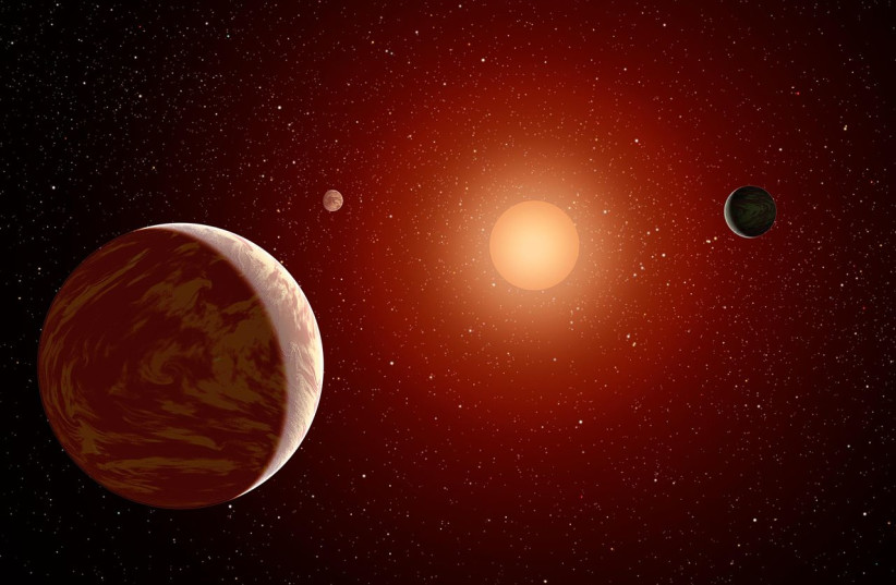  Artistic illustration of planets orbiting a red dwarf star. (credit: Wikimedia Commons)