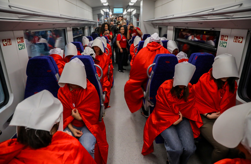 Israelis dressed as characters from The Handmaid's Tale television show arrive to a protest against the Israeli government's planned judicial overhaul, at Yitzhak Navon train station in Jerusalem on March 1, 2023.  (credit: FLASH90)