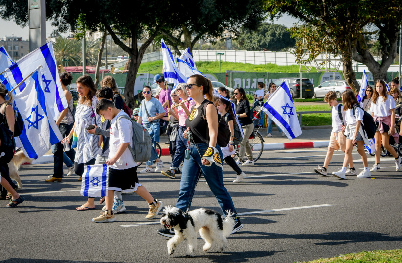  A woman is seen walking her dog amid the judicial reform protests in Tel Aviv, March 1, 2023. (photo credit: AVSHALOM SASSONI/FLASH90)