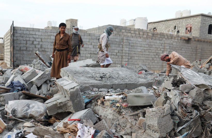 People browse through the rubble of a house destroyed by Houthi missile attack in Marib, Yemen, October 3, 2021 (credit: REUTERS/ALI OWIDHA)
