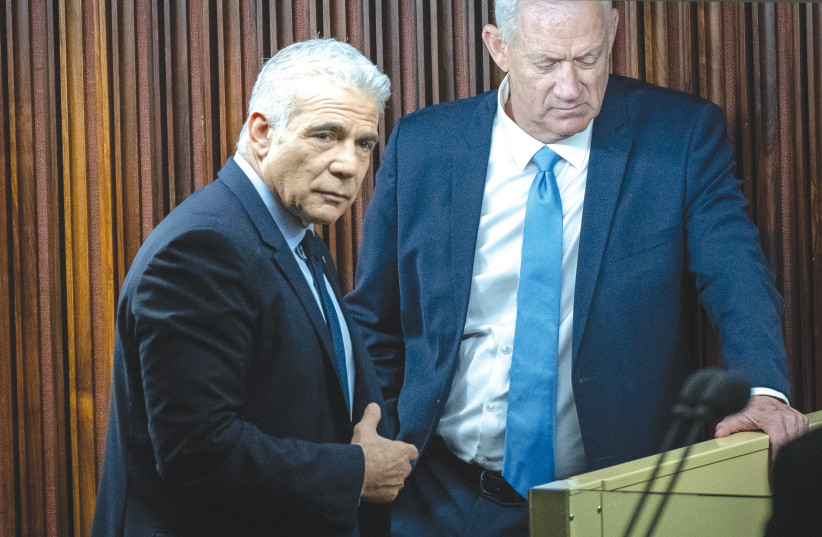  MKS YAIR Lapid and Benny Gantz stand next to each other during a debate in the Knesset plenum last week.  (credit: YONATAN SINDEL/FLASH90)